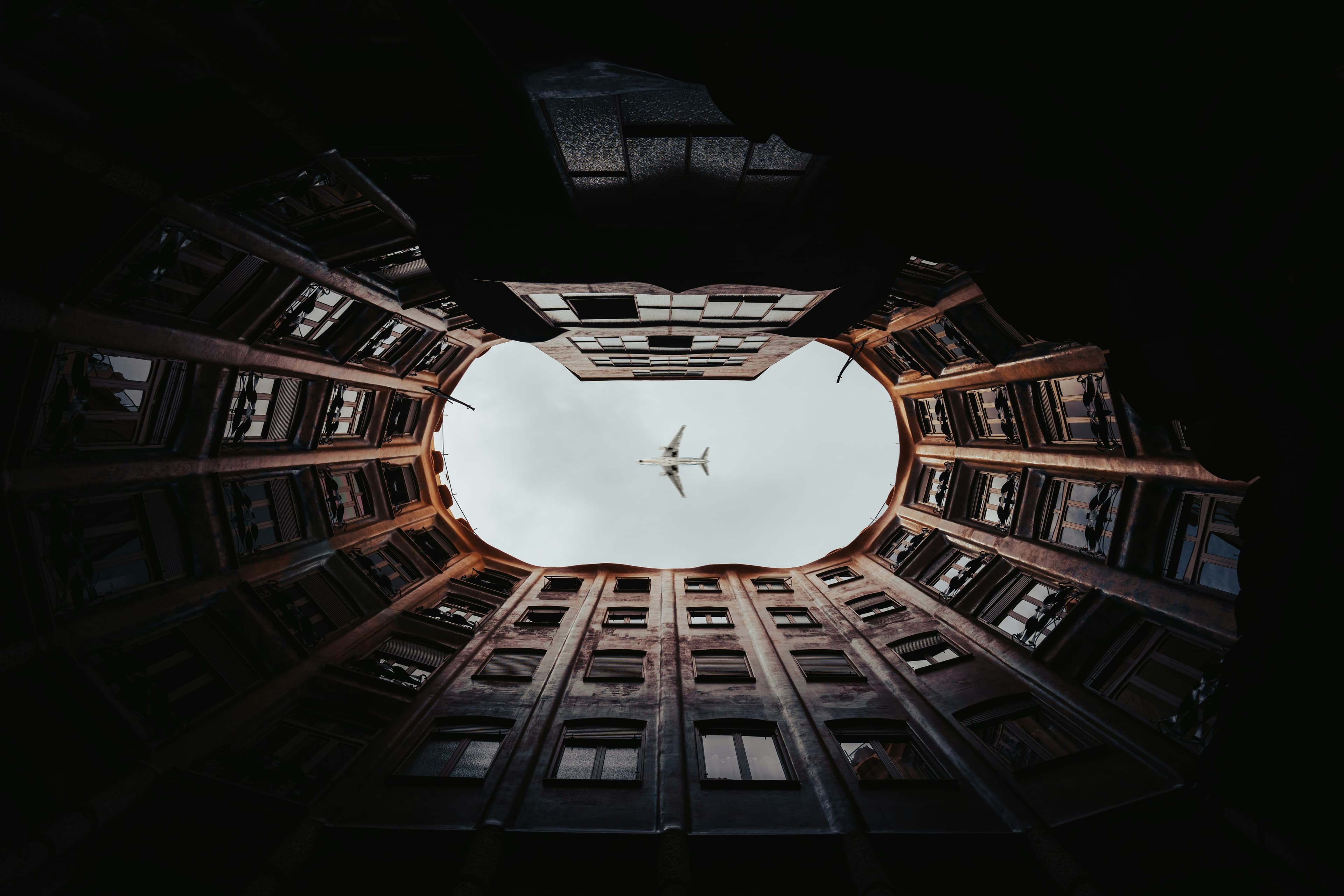 Aircraft flying through building courtyard